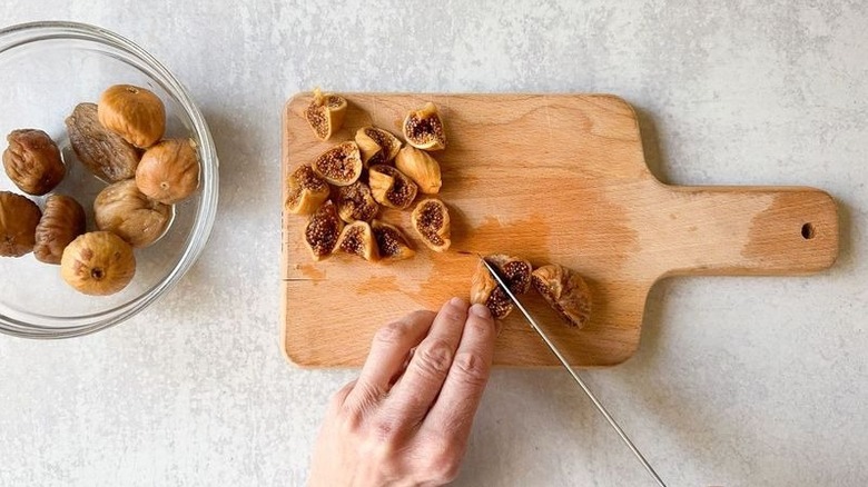 Cutting soaked Turkish figs on cutting board