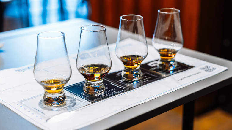 a flight of bourbon glasses lined up for tasting
