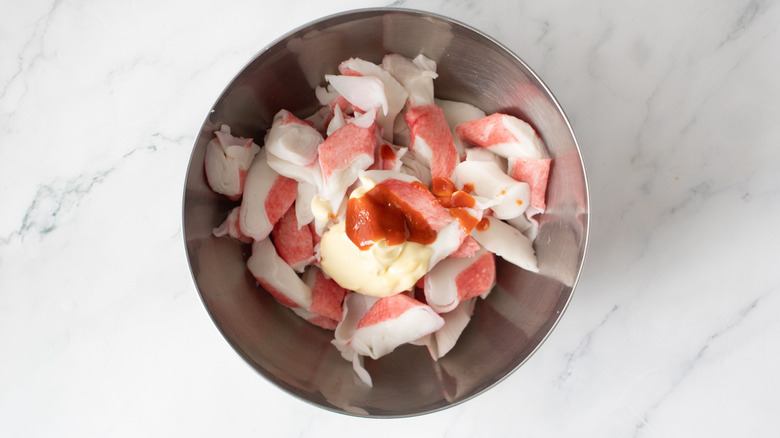 Imitation crab, mayonnaise, and sriracha in bowl
