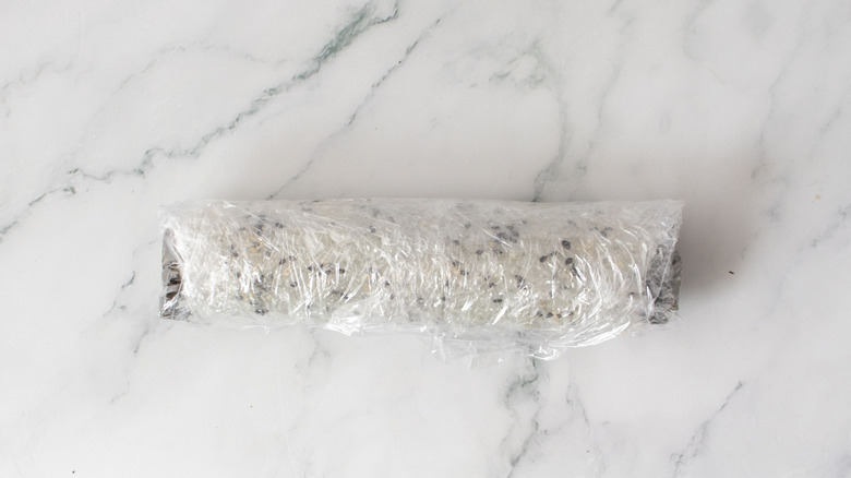 Sushi roll in plastic wrap