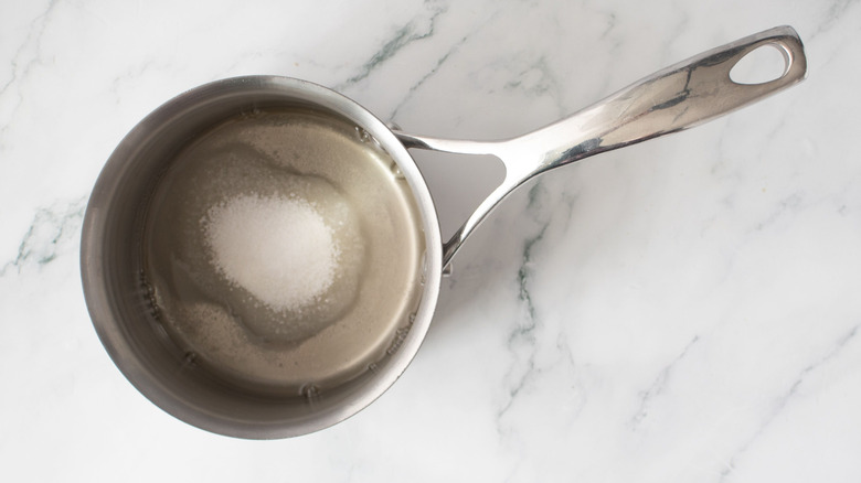 Salt, sugar, and liquid in saucepan