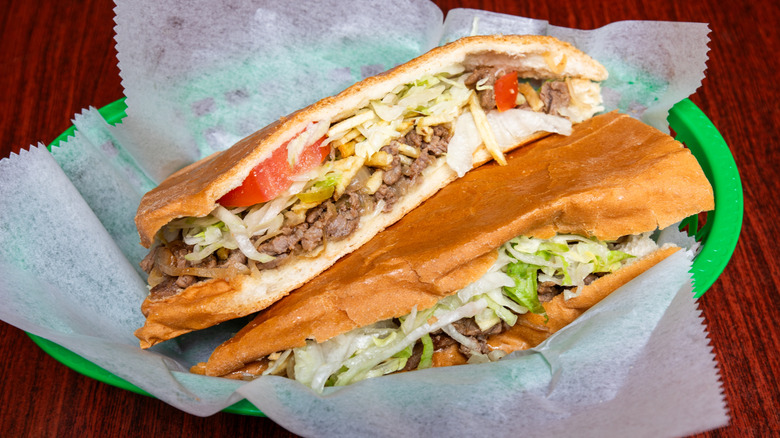 A hearty, jam-packed Cuban sandwich on a green plate