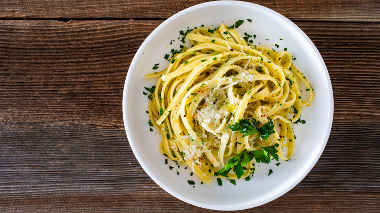 a bowl of pasta with parsley and cheese