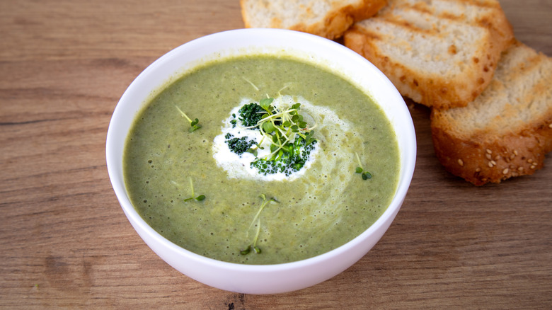 A bowl of creamy soup with toasted bread.