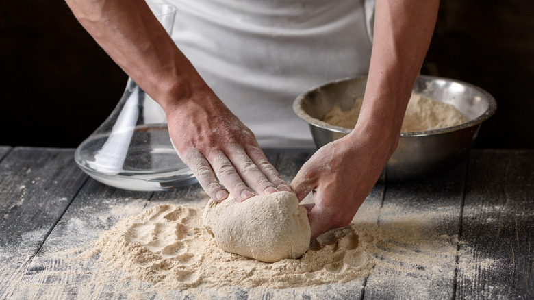 Kneading dough on a wooden table