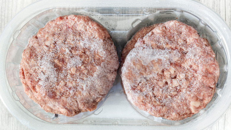 Frozen burgers with ice on the surface