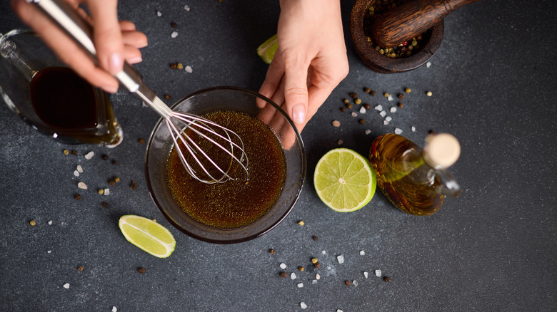 person whisking sauce