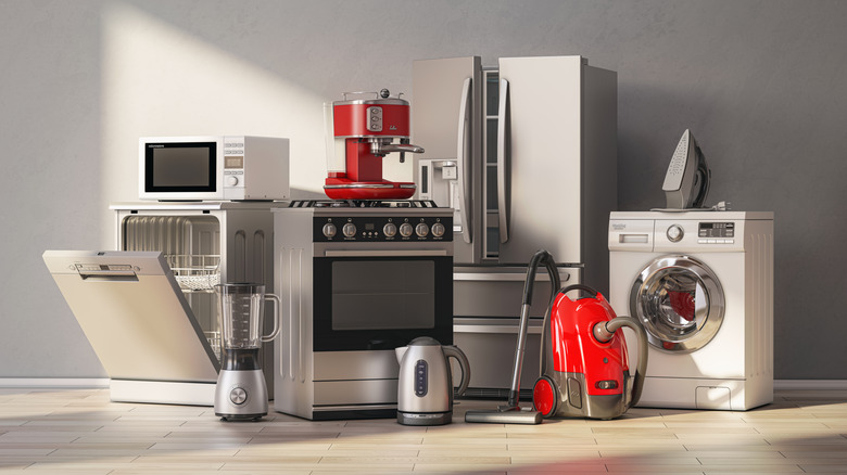 A cluster of kitchen appliances includes a dishwasher, range, refrigerator, and microwave, among other items.