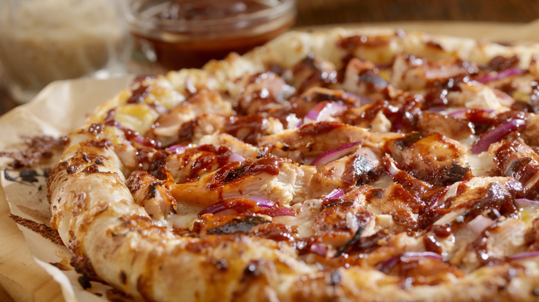A BBQ chicken pizza with red onions