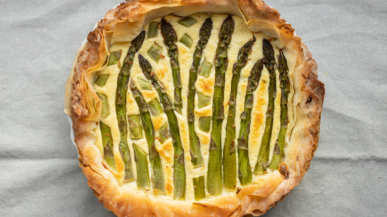 Quiche topped with asparagus