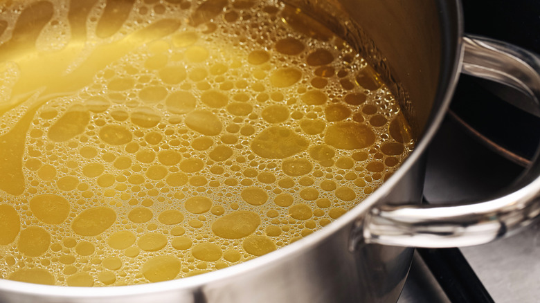 Chicken stock heating on a stovetop