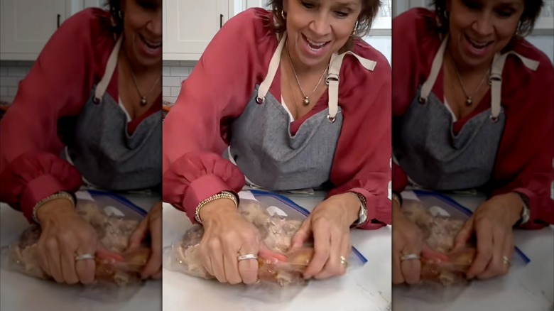 Woman kneeding a plastic zippered bag with a roasted chicken