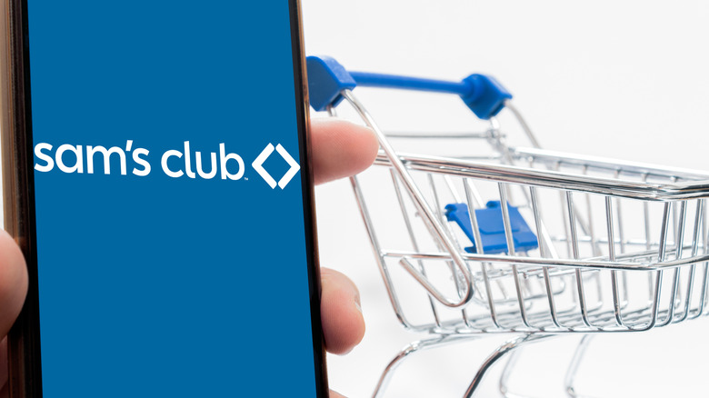 Sam's Club logo on a phone in front of buggy