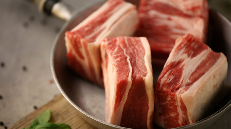 Raw beef short ribs in skillet