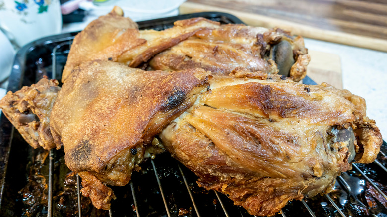 roasted chicken resting on rack