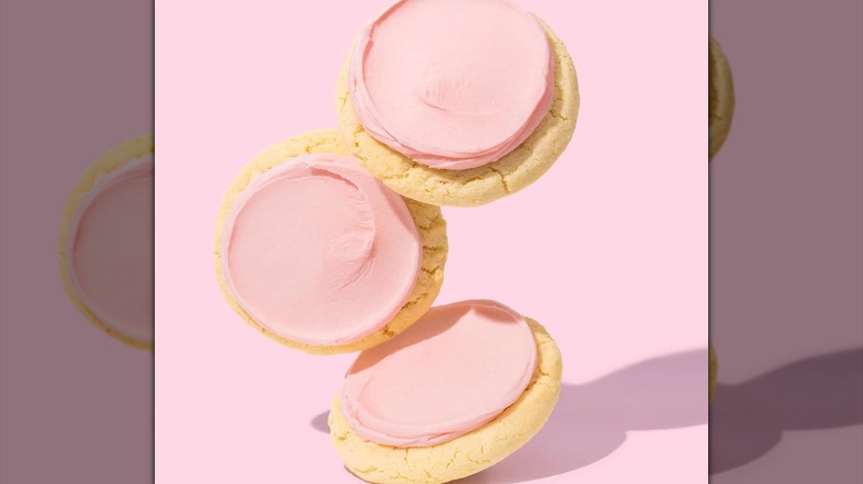 Pink frosted sugar cookies with pink background