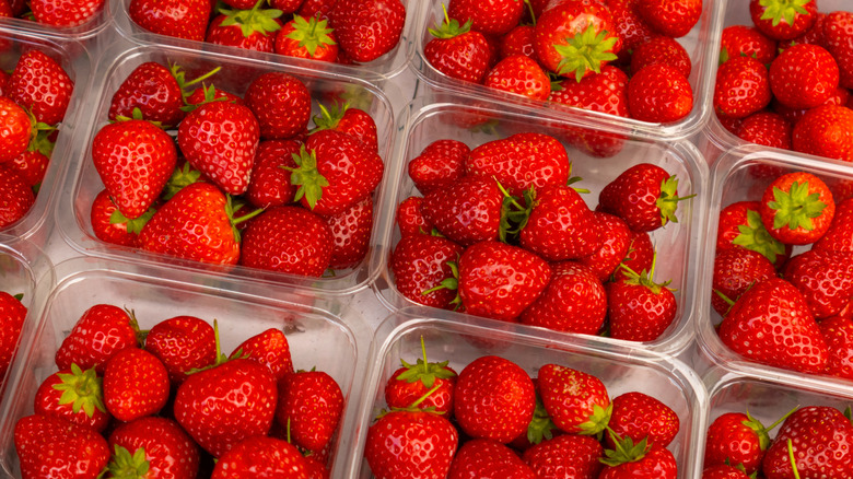 Red strawberries in plastic containers.
