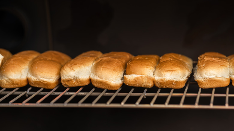 Hot dog buns toasting on a grill