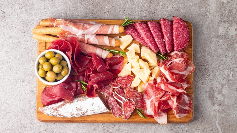 Charcuterie board with meats, cheeses, and olives