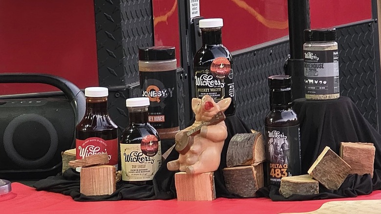 Various Wicker's barbecue products, including its original baste and marinade, premium Top Shelf and Whiskey Wagyu bastes and marinades, DeltaQ 483 sauce, and seasonings, sit on a table at the 3rd Annual Wicker's Tour of Champions, Cleveland, Mississippi.