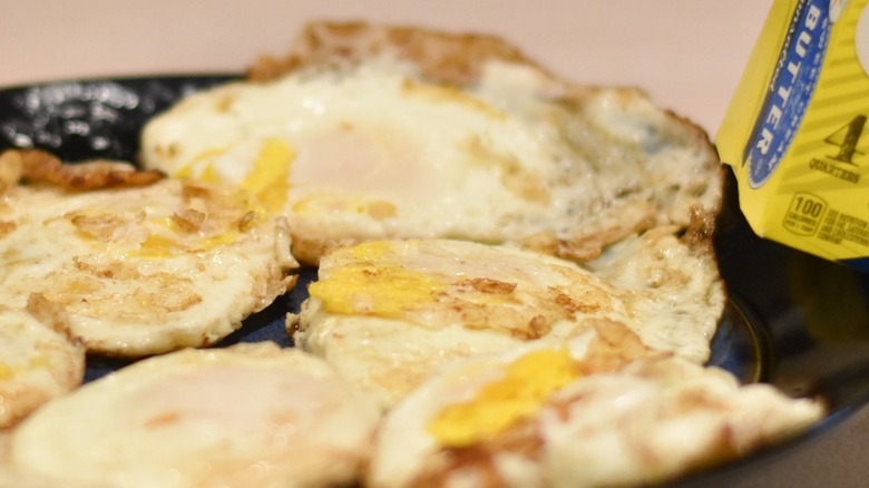 A plate of fried eggs cooked in butter