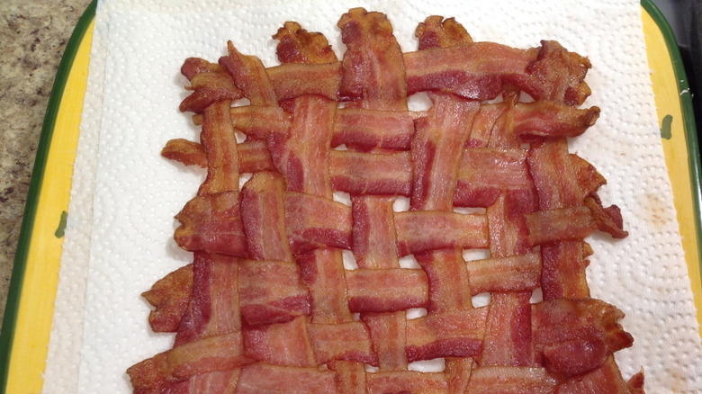 cooked bacon woven together on paper towels
