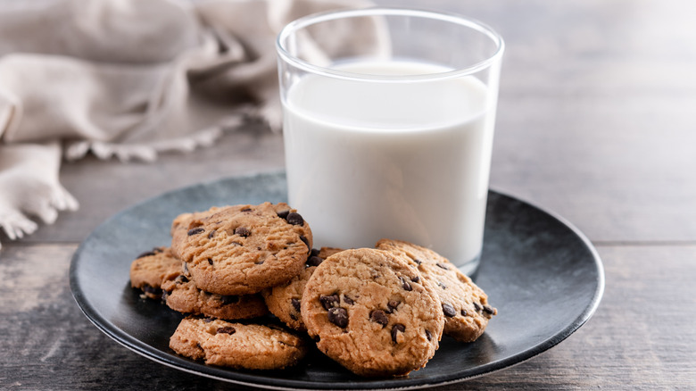 Cookies and a glass of milk on a gray plate
