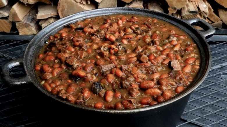 brisket and baked beans in a large cast iron pot