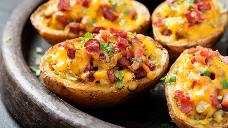 Cheesy, baked potatoes with bacon bits on top.