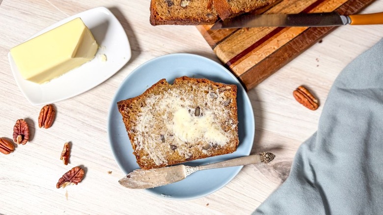 Bakery-worthy banana bread slice spread with butter