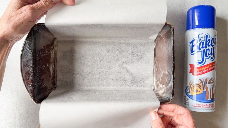 Loaf pan lined with parchment paper and Baker's Joy