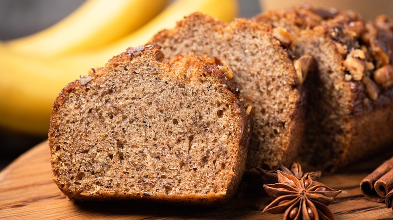 Slices of banana bread in front of a loaf, closeup view