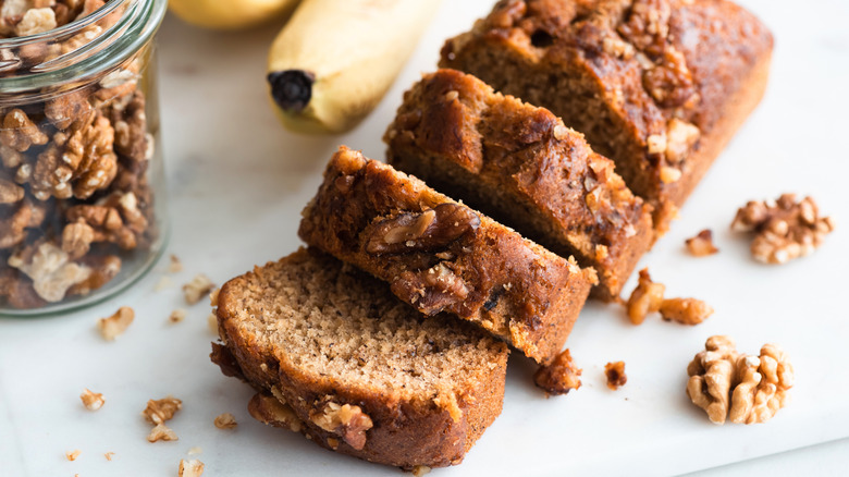 Closeup slightly overhead view of homemade banana bread with walnuts cut into slices