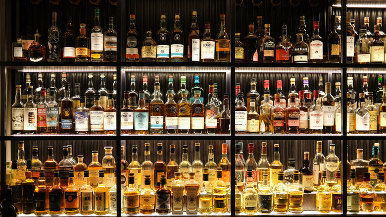 Various bottles of alcohol set up behind a bar