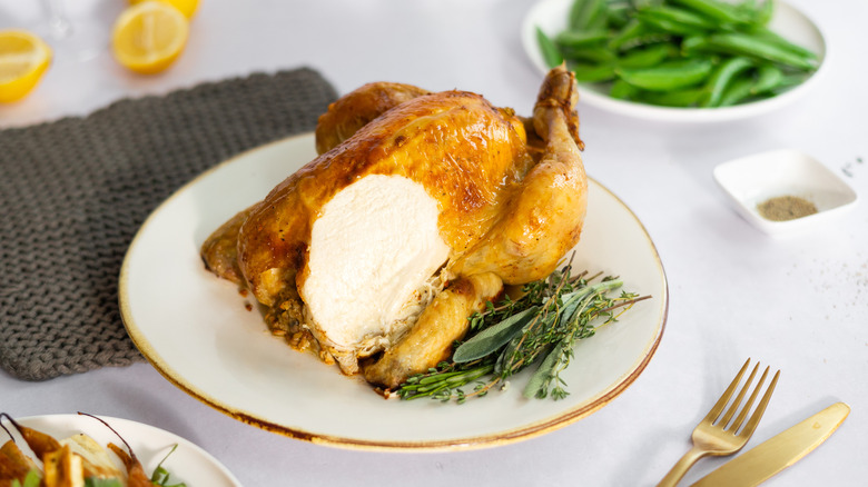 roast chicken sliced to show succulent meat 