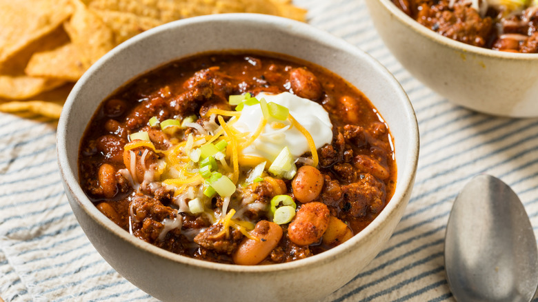 bowl of chili garnished with sour cream
