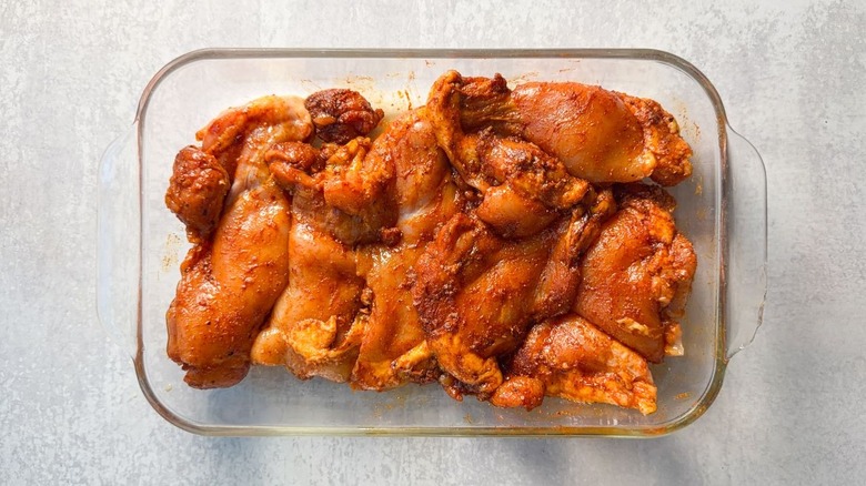 Dry-rubbed chicken thighs in glass baking dish