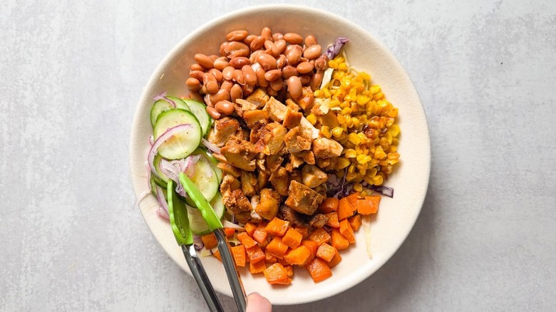 BBQ in a bowl chicken salad in serving bowl with tongs