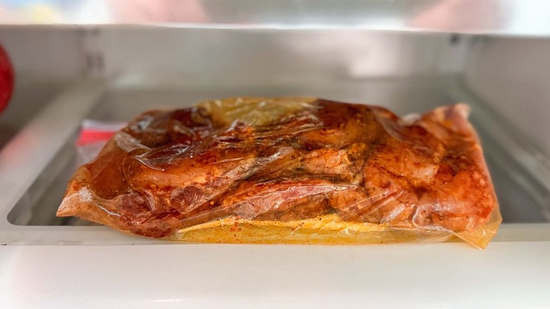 Dry rub chicken thighs in ziplock bag in refrigerator