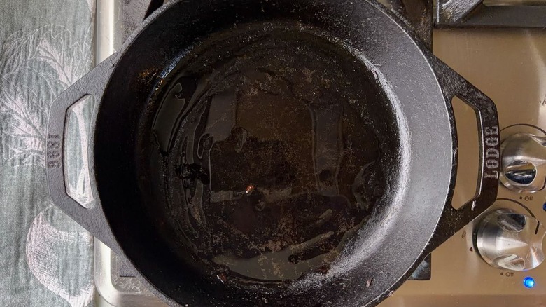 Cast iron skillet with oil on stovetop