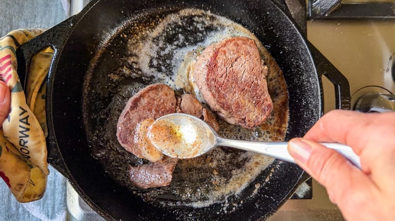 Basting filet mignon with melted butter and Worcestershire sauce