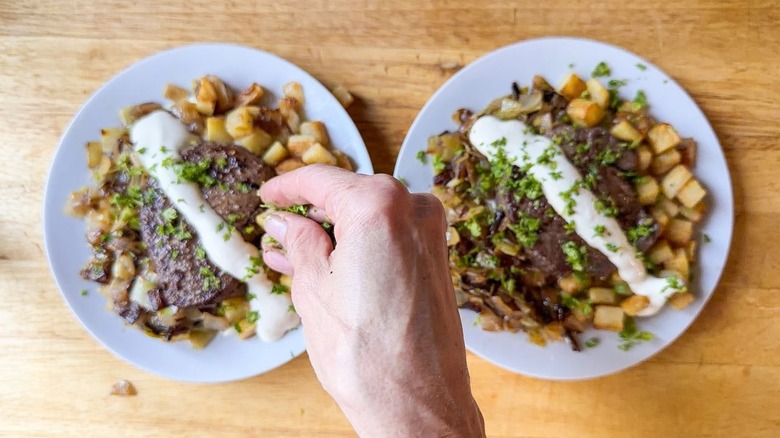 Adding chopped chervil to beef Rydberg-style steak and potatoes