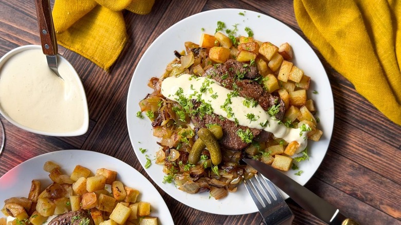 Beef Rydberg-style steak and potatoes on plates with mustard cream sauce