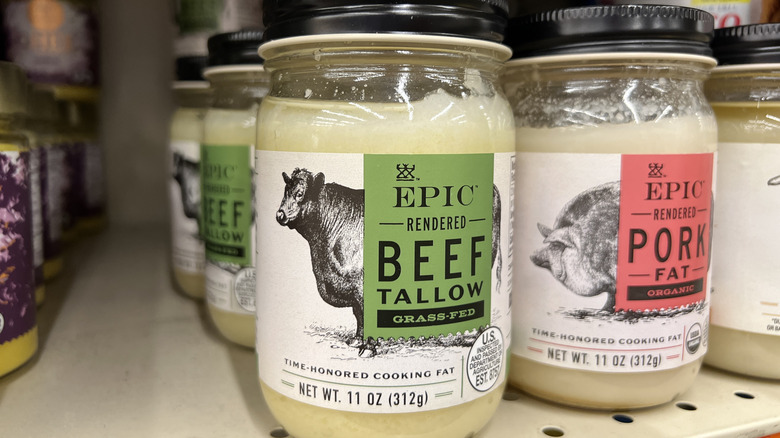 Jars of beef tallow on a supermarket shelf.