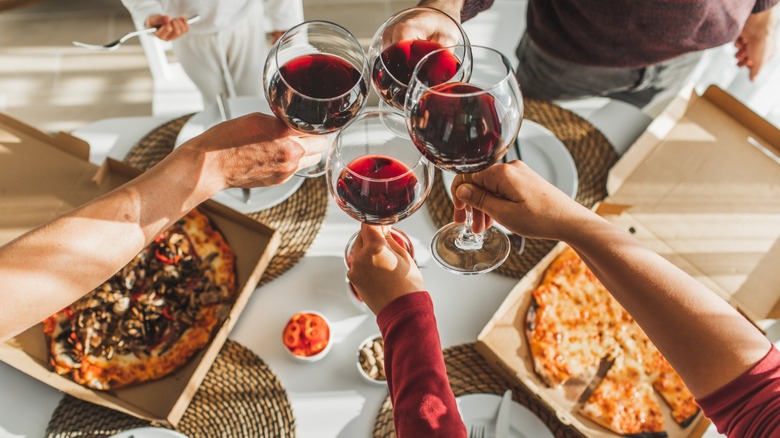 Toasting with glasses of red wine