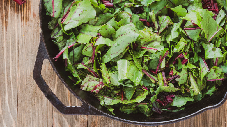 Beet greens in a cast iron skillet.