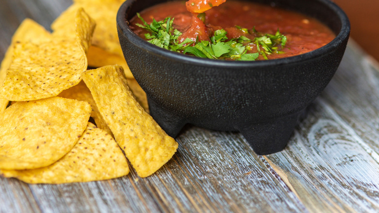 dipping chips into salsa
