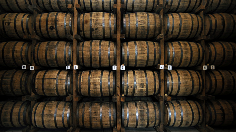 whiskey aging in barrels in a rickhouse