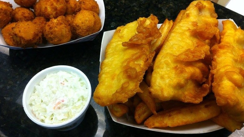 Hush puppies and battered fish with a side of coleslaw