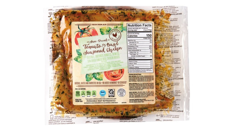 A package of Aldi's Fresh Sundried Tomato & Basil Seasoned Chicken on a white background